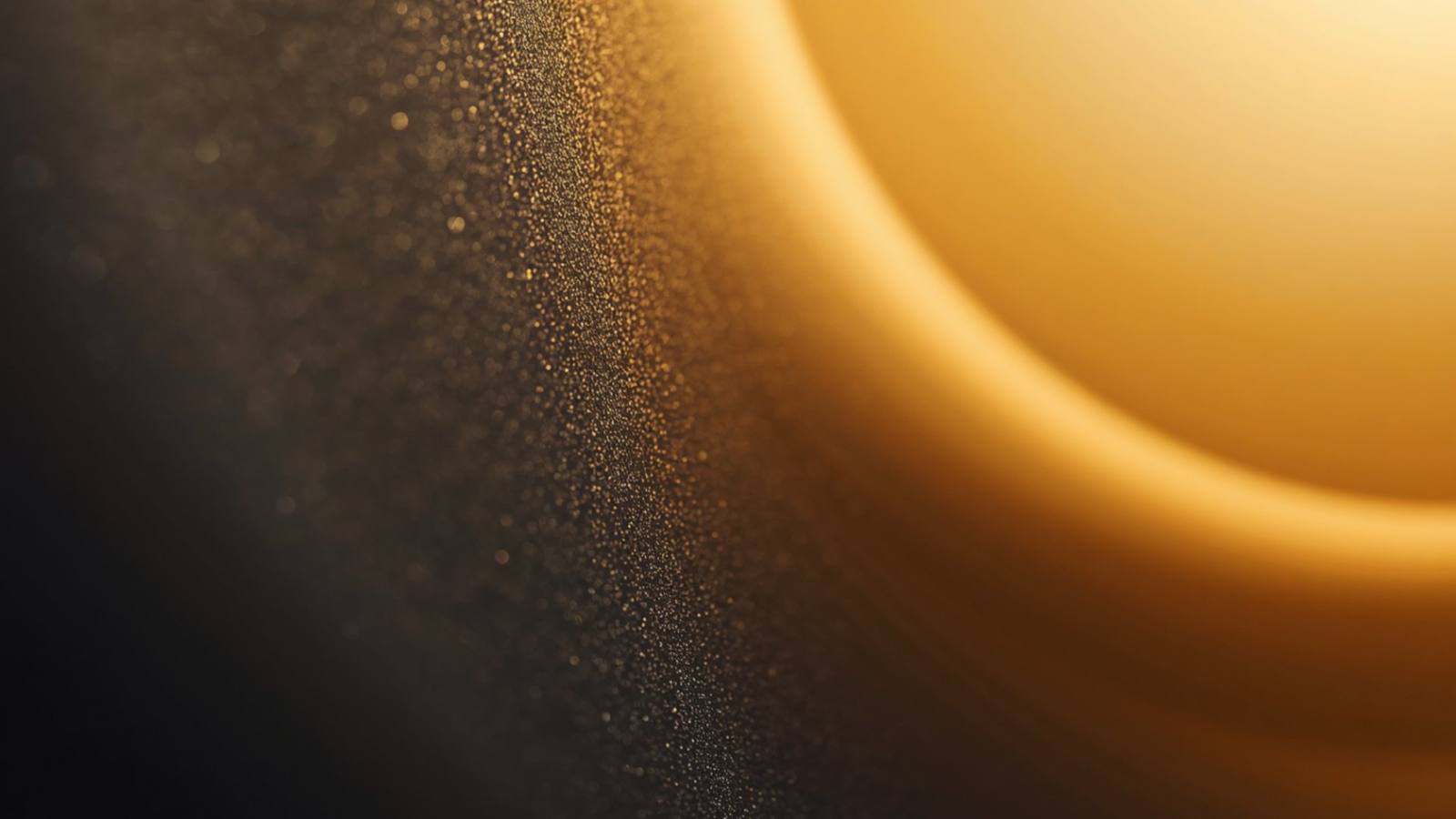 Abstract gold light and particles against a dark background